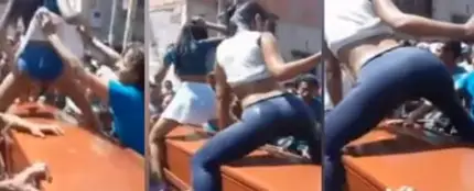Dos chicas bailando reggaeton sobre un ataúd Dos chicas bailando reggaeton sobre un ataúd