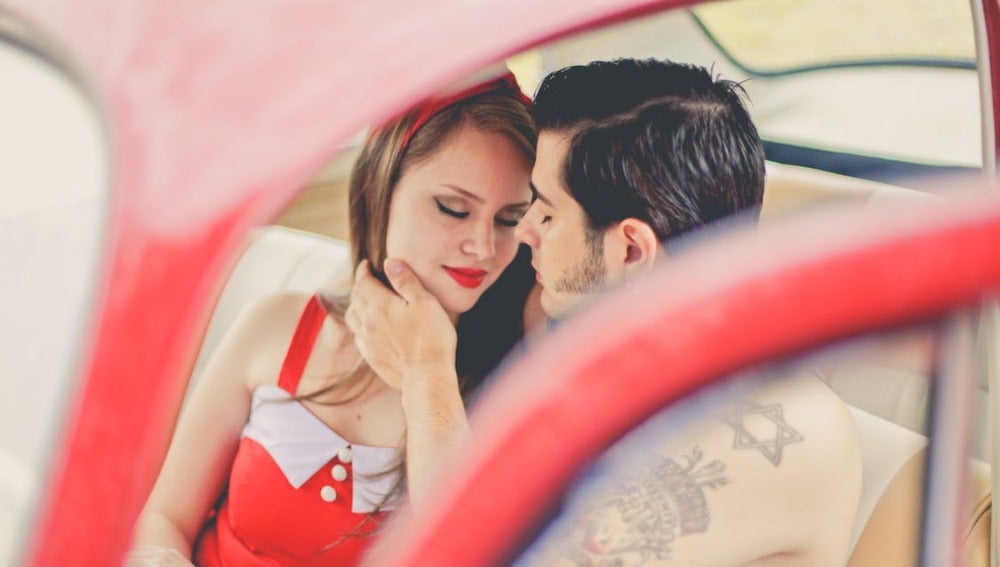 Una pareja se besa en el coche