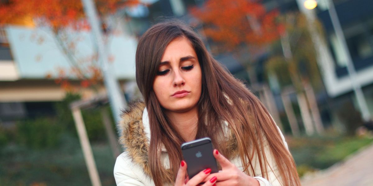 Una adolescente mira el móvil