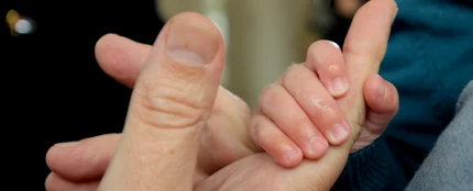 Las manos de un adulto y un bebé Las manos de un adulto y un bebé