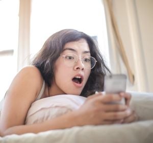 Una chica asombrada mirando el móvl Una chica asombrada mirando el móvl
