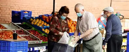 Varias personas hacen sus compras en un mercadillo en Madrid Varias personas hacen sus compras en un mercadillo en Madrid