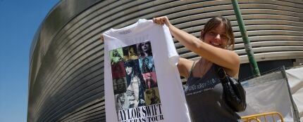 Una mujer sujeta una camiseta de merchandaising, en los alrededores del Estadio Santiago Bernab&eacute;u, a 28 de mayo de 2024, en Madrid (Espa&ntilde;a)