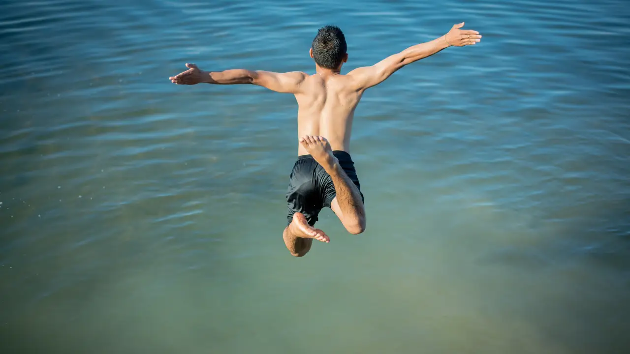 Un chico tirándose al agua Un chico tirándose al agua