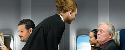 Una azafata de vuelo atendiendo a un pasajero Una azafata de vuelo atendiendo a un pasajero
