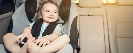 Una niña en su sillita infantil Una niña en su sillita infantil