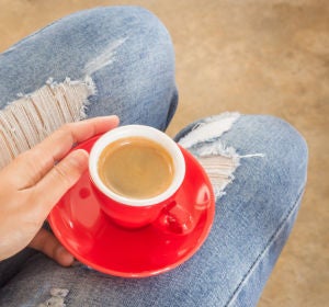 Chica con jeans tomándose un café Chica con jeans tomándose un café